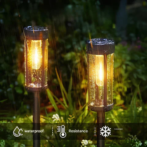 Set of SolarFlare solar torches illuminating a garden path, creating a magical outdoor atmosphere