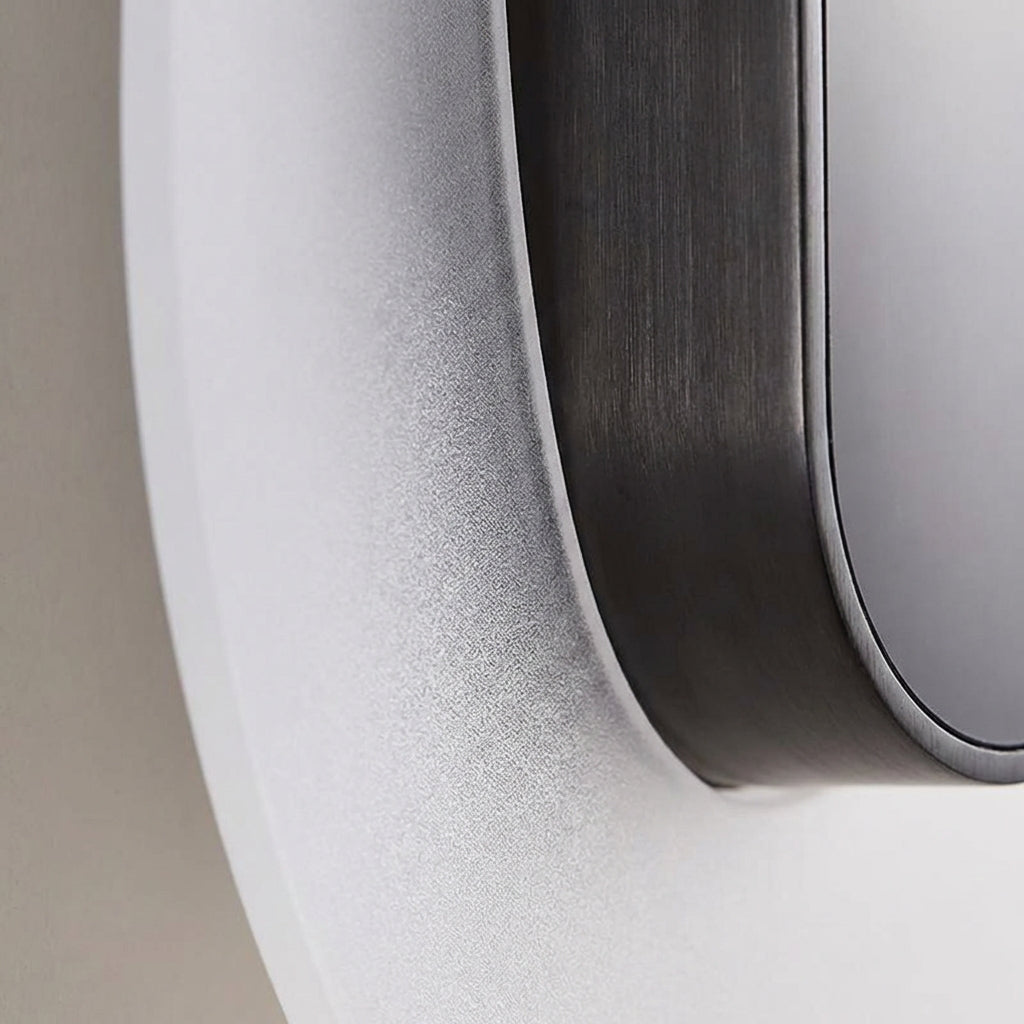 Outdoor lighting: Solenyx LED round wall sconce with sleek modern design on an exterior wall