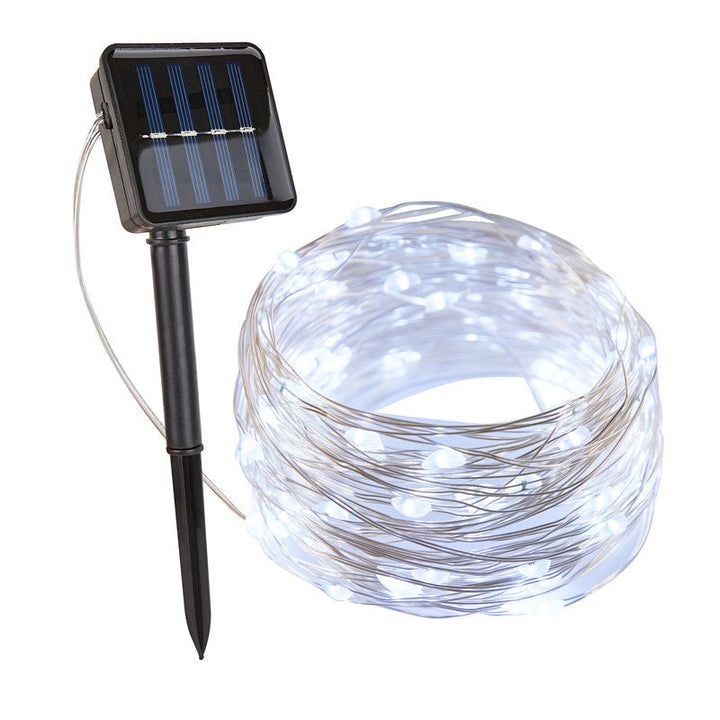 Waterproof SoliGlow solar string lights reflecting in a garden pond, beautiful outdoor lighting.