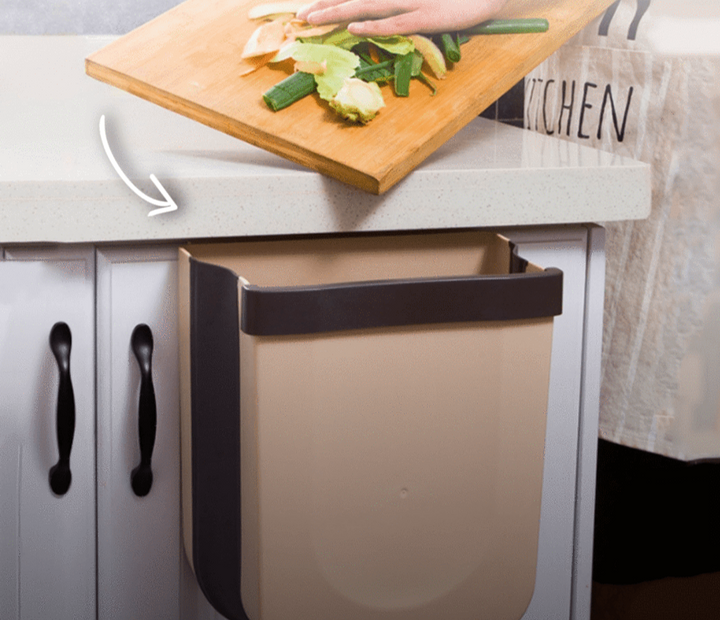 White foldable wall waste bin for kitchen, optimizing space. Ideal for daily garbage & efficient home storage.