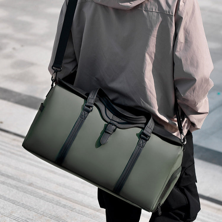 Side view of a black duffle bag, highlighting the convenient shoe compartment, great for gym or travel.
