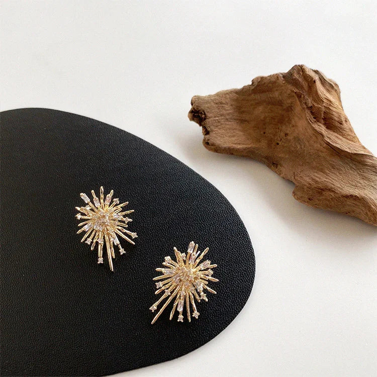 Elegant women's gold firework zirconia earrings, perfect for special occasions, adding a sparkling touch.