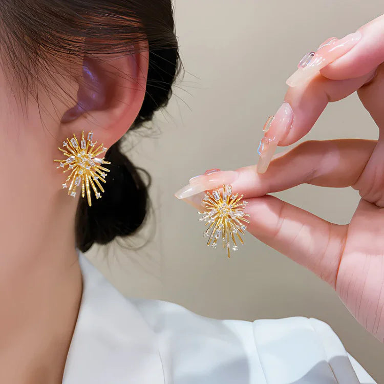 Close-up of dazzling gold firework zirconia earrings for women, hypoallergenic & comfortable sterling silver.