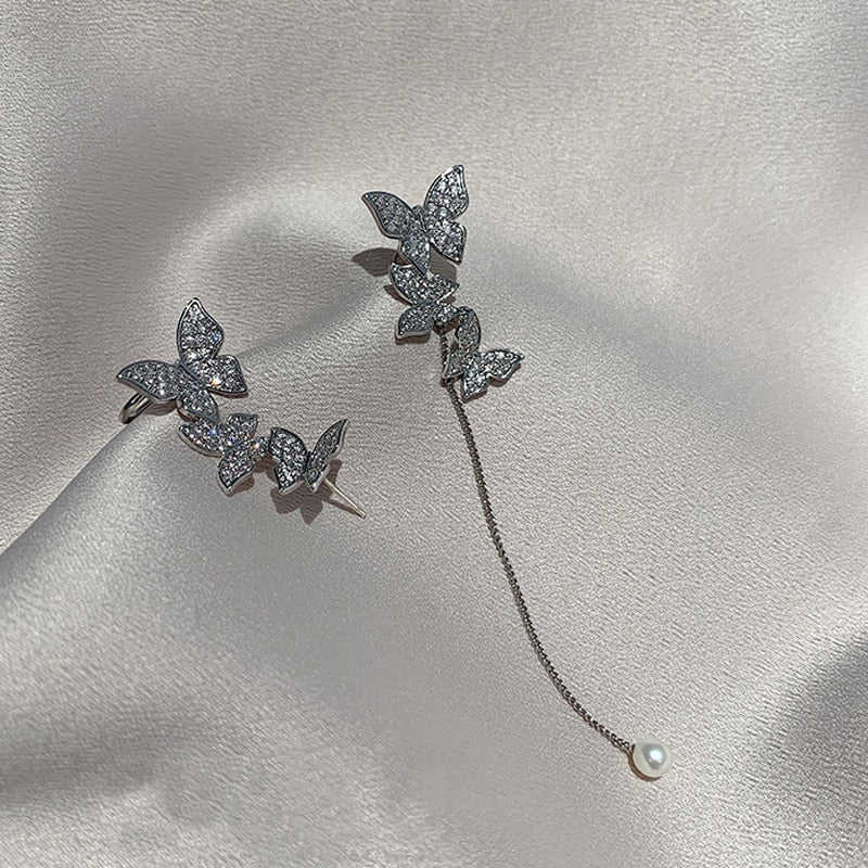 Silver tone dangle earrings adorned with multiple sparkling rhinestones for women.