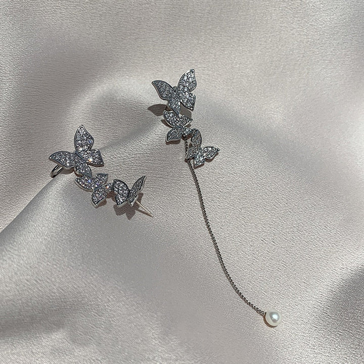 Silver tone dangle earrings adorned with multiple sparkling rhinestones for women.