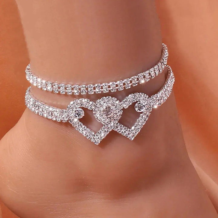 Sparkling rhinestone heart pendant body chain for women, glamorous statement jewelry perfect for parties.