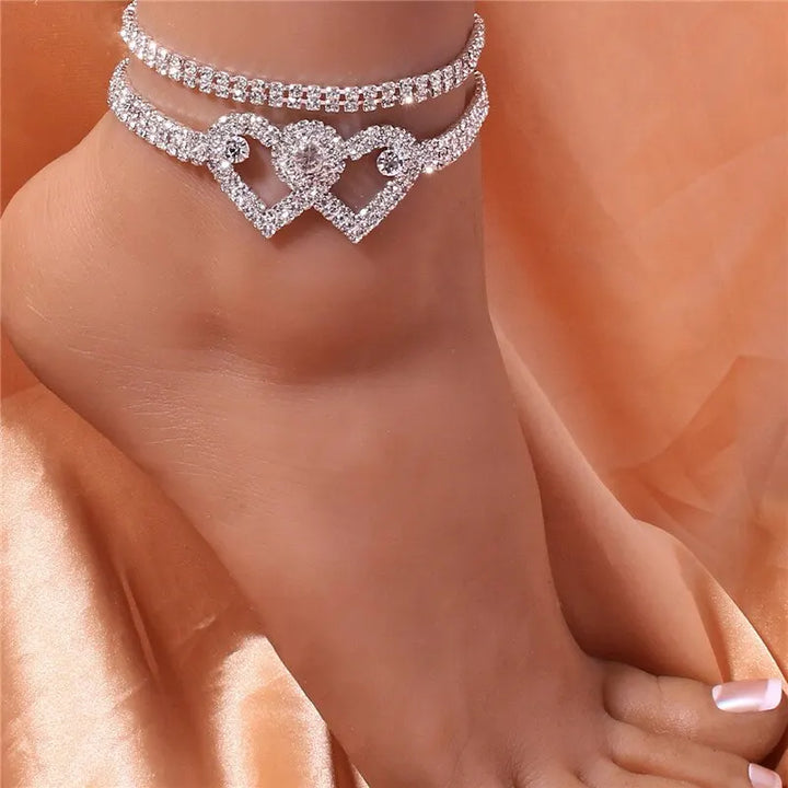 Women's fashion body chain with a sparkling rhinestone heart pendant, a glamorous and eye-catching accessory.