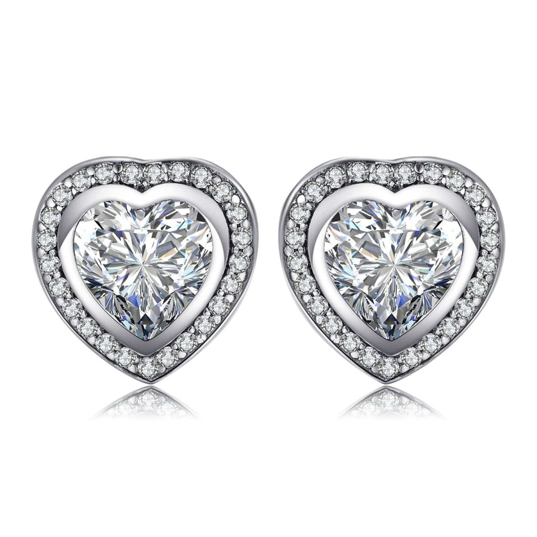 Close-up of sparkling zirconia heart earrings in silver, ideal gift for her. Women's delicate jewelry.