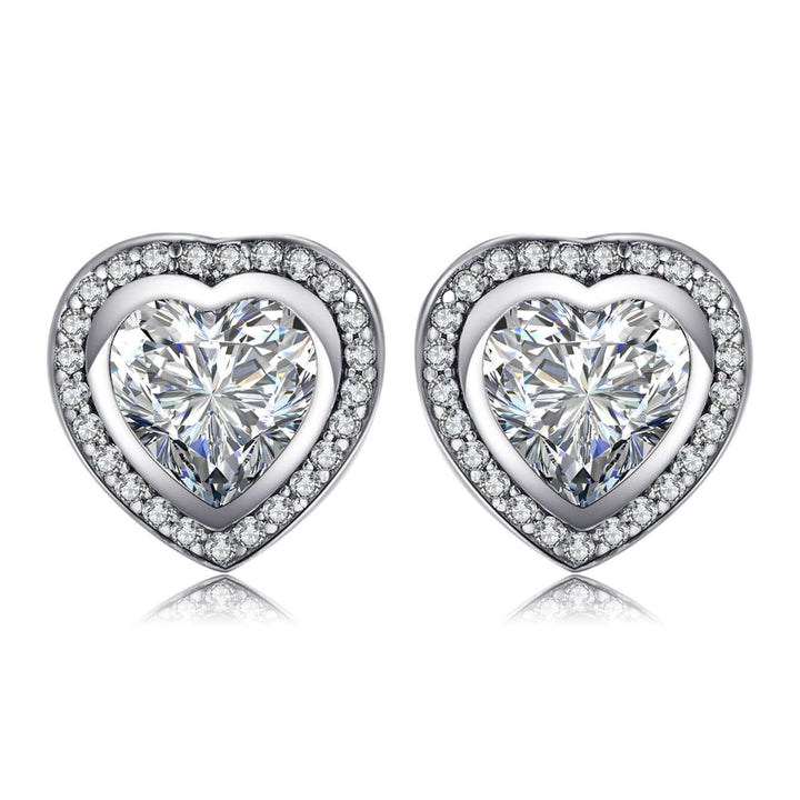 Close-up of sparkling zirconia heart earrings in silver, ideal gift for her. Women's delicate jewelry.