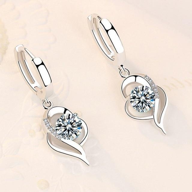 Women's elegant silver earrings with sparkling zirconia floral inlay. Perfect dangle earrings for special occasions.