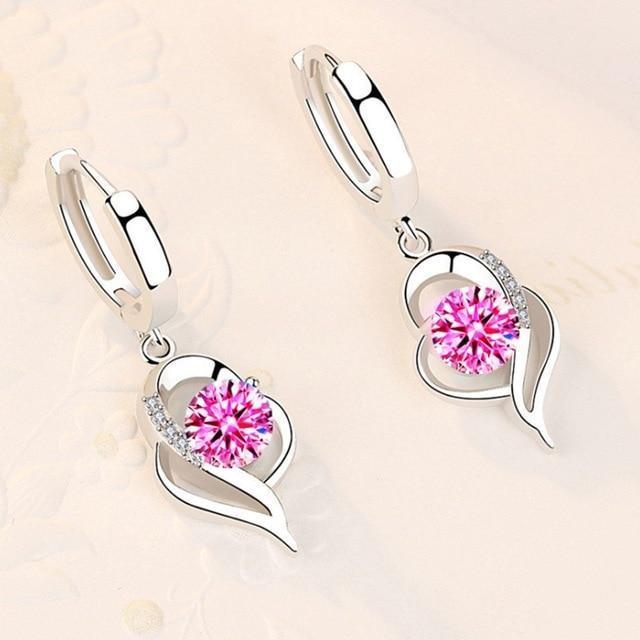 Dazzling zirconia flower silver earrings for women. Sterling silver dangle design, ideal as a gift for her.