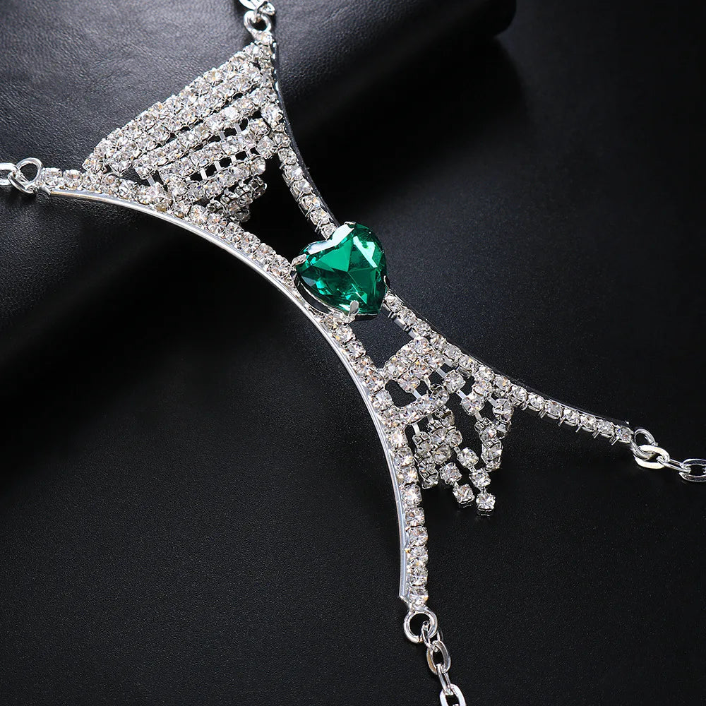 Elegant silver tone heart crystal body chain for women, a glamorous rhinestone chest accessory.