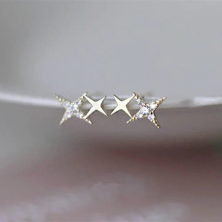 Close-up of women's sparkling star stud earrings, featuring intricate design and clear zirconia stones.