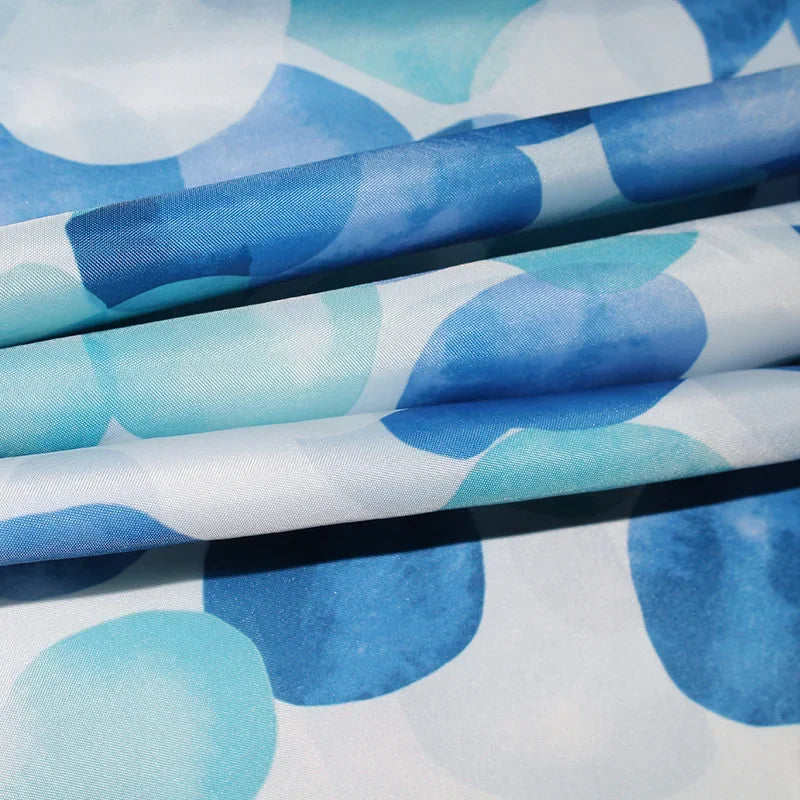 Detail of SplashDot shower curtain's reinforced buttonholes for long-lasting use with hooks