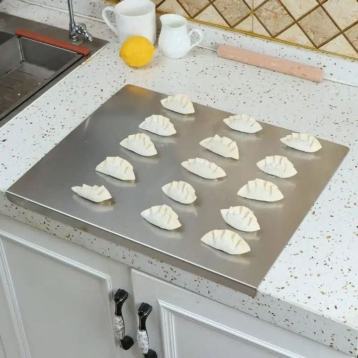 Non-slip stainless steel cutting board with integrated lip for secure kitchen food preparation. Dishwasher safe.