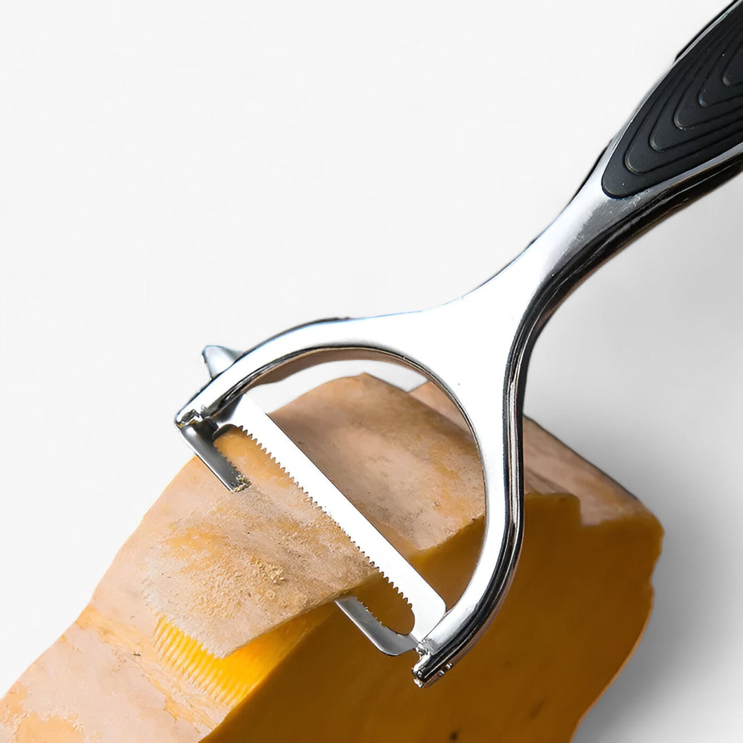 Versatile stainless steel peeler for carrots, potatoes, & apples. Essential kitchen slicing gadget.