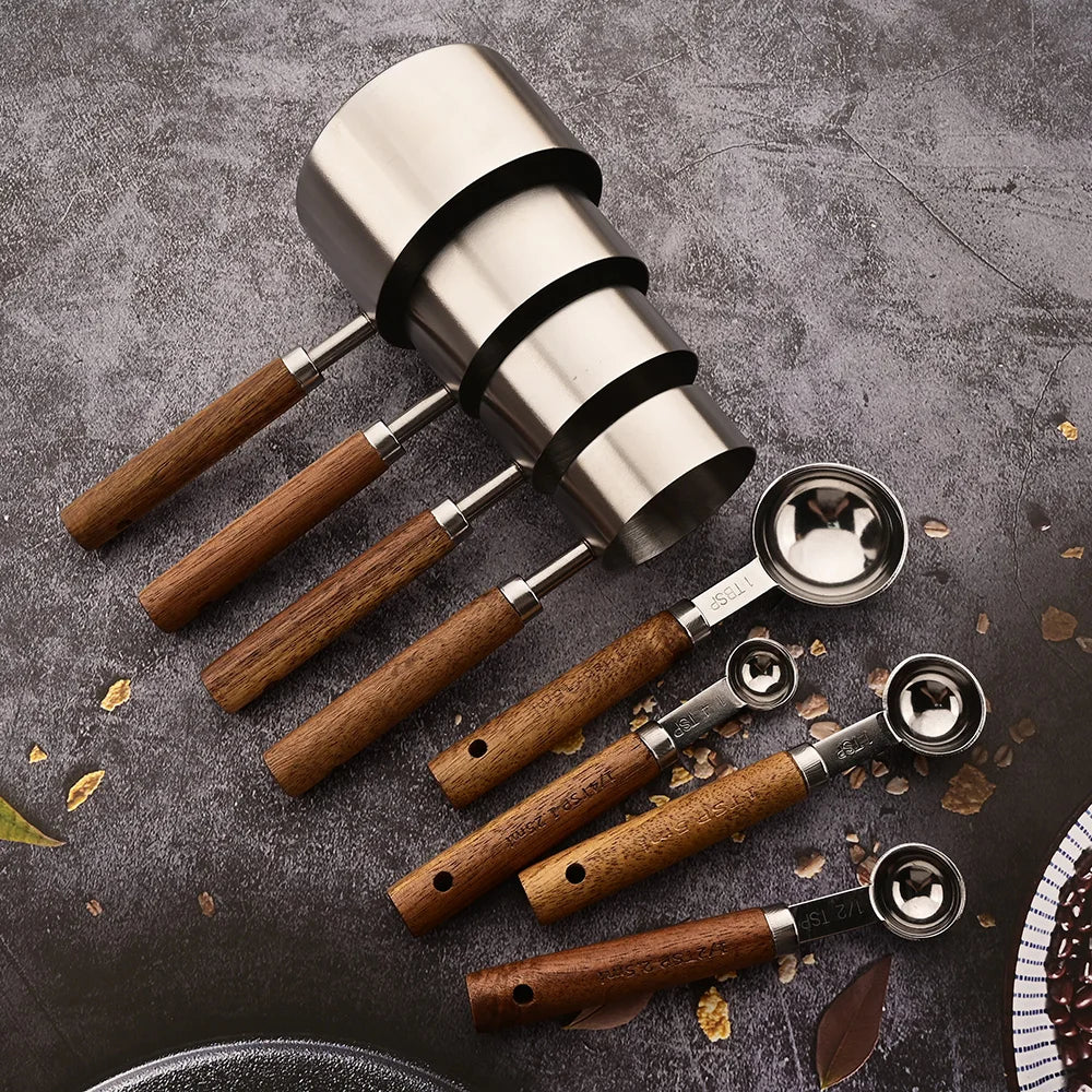 Premium baking supplies: A set of stainless steel measuring spoons with ergonomic wood handles.