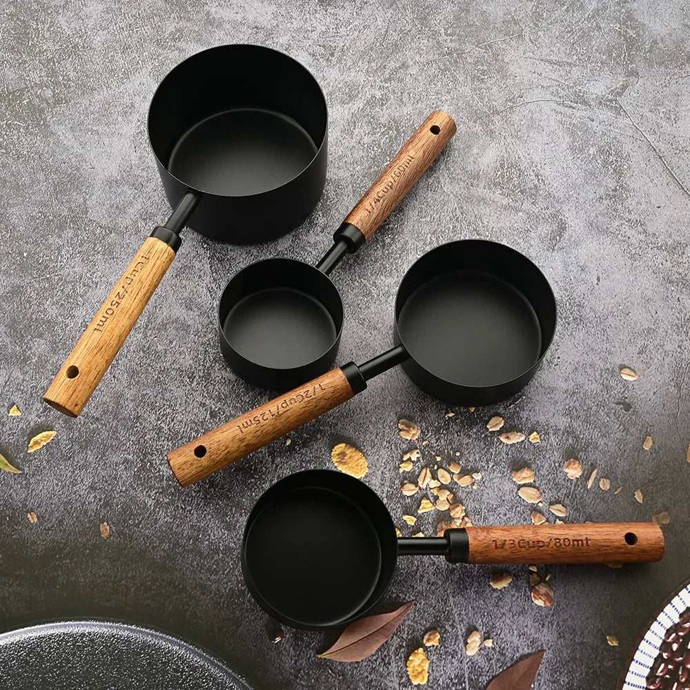 Modern kitchen tools: Stainless steel measuring spoons with beautiful wood handles, ideal for cooking.
