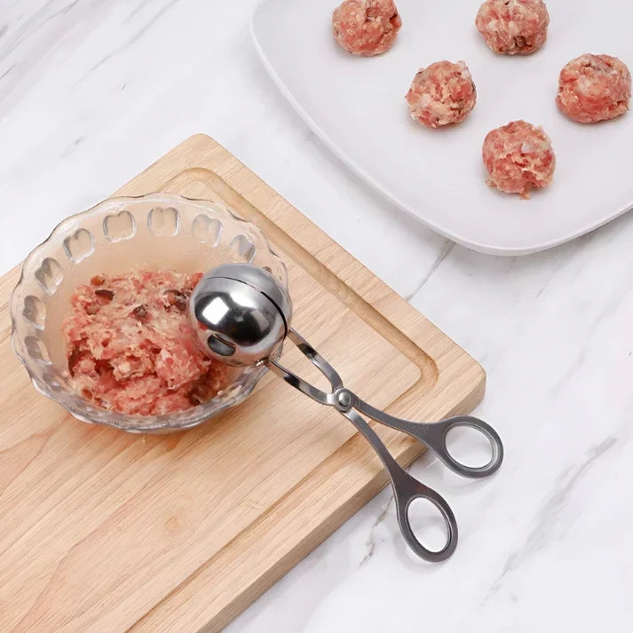 Versatile stainless steel tool for making perfect meatballs, rice balls, and other food prep items.