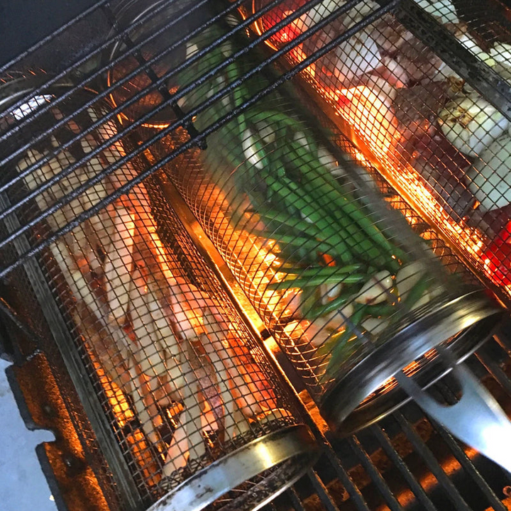 Heavy-duty stainless steel rolling BBQ basket, a versatile kitchen tool for grilling.
