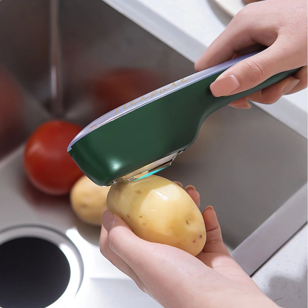 Stainless steel vegetable peeler with a built-in container for mess-free food prep. Keep your kitchen tidy.