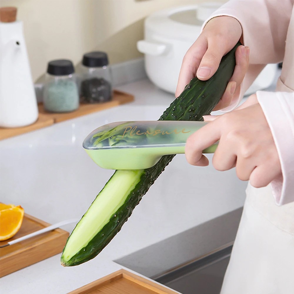 Modern kitchen gadget: Stainless steel vegetable peeler. Features a catch container for peels, ensuring a clean cooking area.