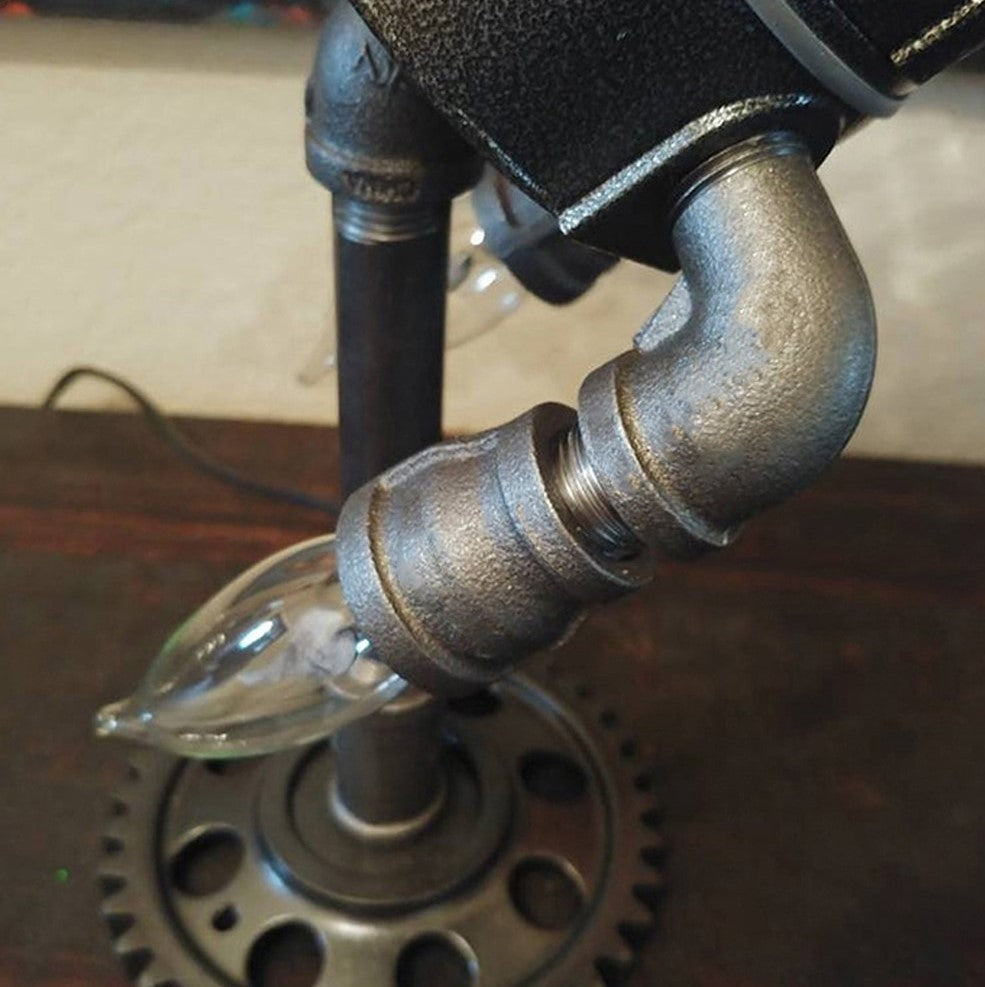 Stylish Steampunk Rocket Table Lamp providing unique ambient light, a focal point for any desk or room