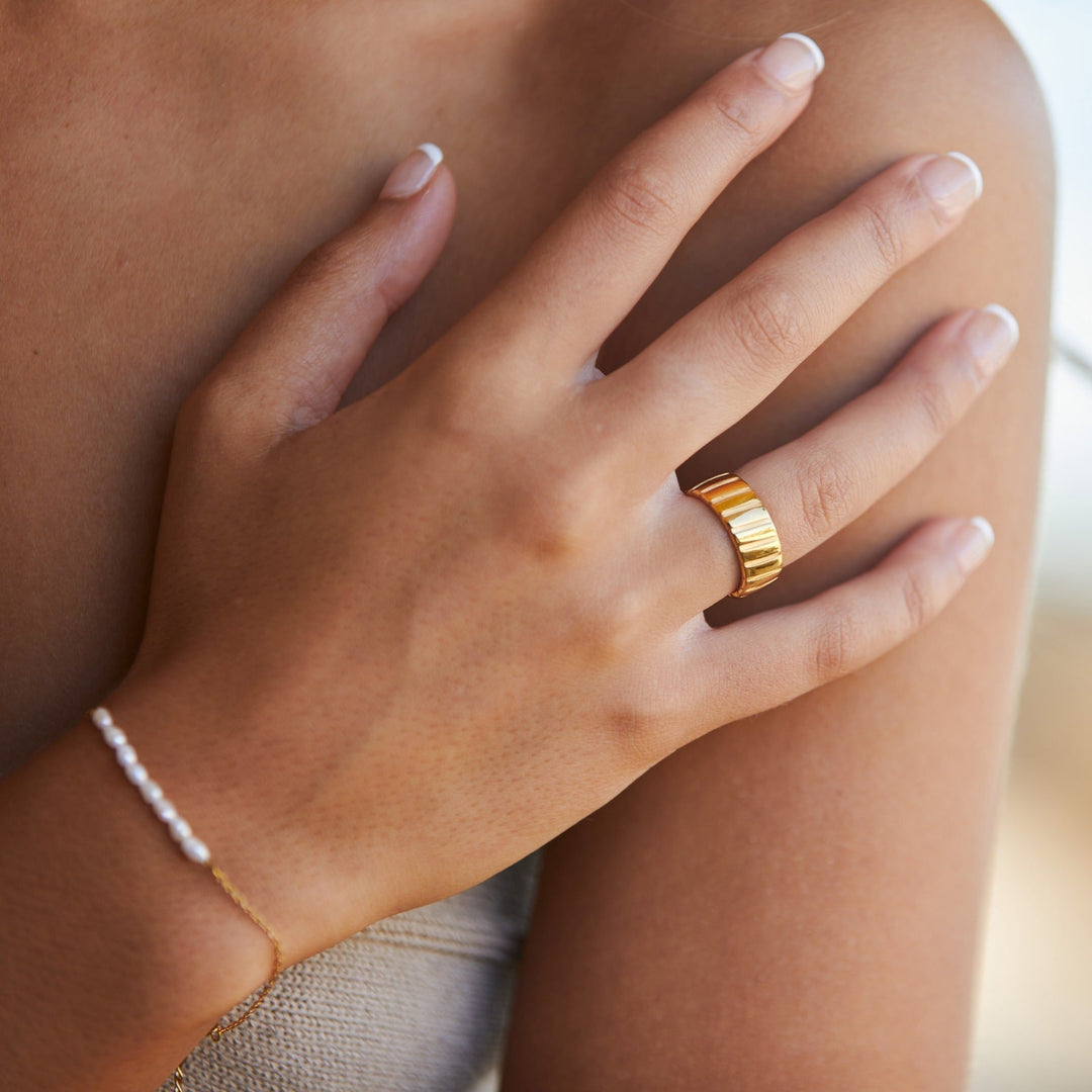 Women's bold gold statement ring, a modern fashion accessory perfect for an elevated, stylish look.