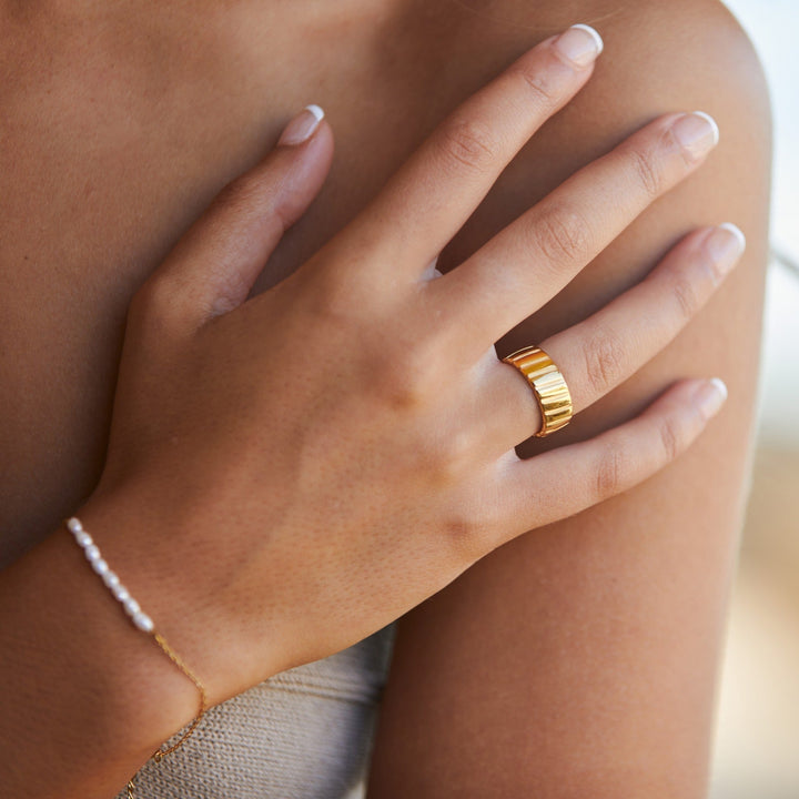 Women's bold gold statement ring, a modern fashion accessory perfect for an elevated, stylish look.