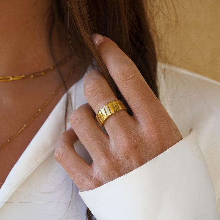 Fashion-forward bold gold statement ring for women, a modern metal accessory for an elevated look.