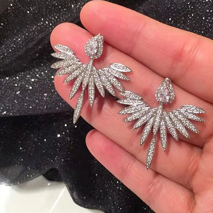 Delicate sterling silver angel wing studs for women, a symbolic and elegant jewelry gift.