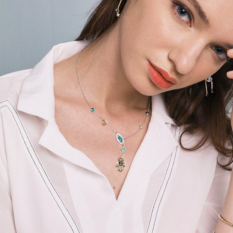 Elegant silver Hamsa crystal necklace, a spiritual jewelry piece and a beautiful accessory for women.