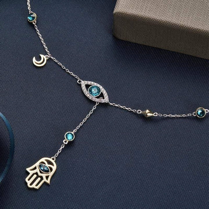 Dainty sterling silver Hamsa pendant with dazzling crystal detailing, a chic women's necklace.