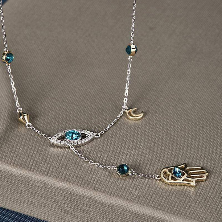 Polished silver Hamsa charm necklace adorned with clear crystals, a stylish women's accessory.