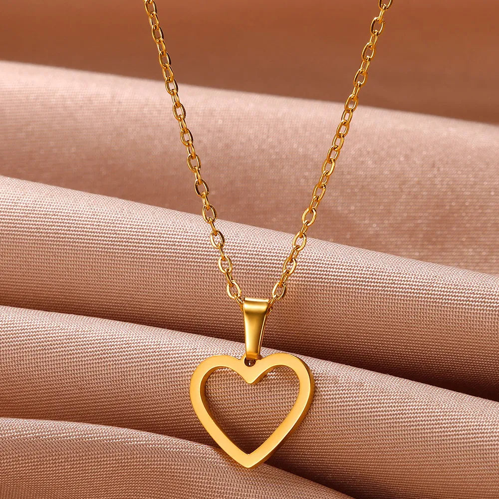 Women wearing elegant sterling silver heart pendant necklace, enhancing their neckline.