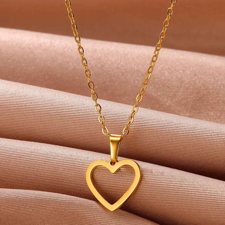 Women wearing elegant sterling silver heart pendant necklace, enhancing their neckline.