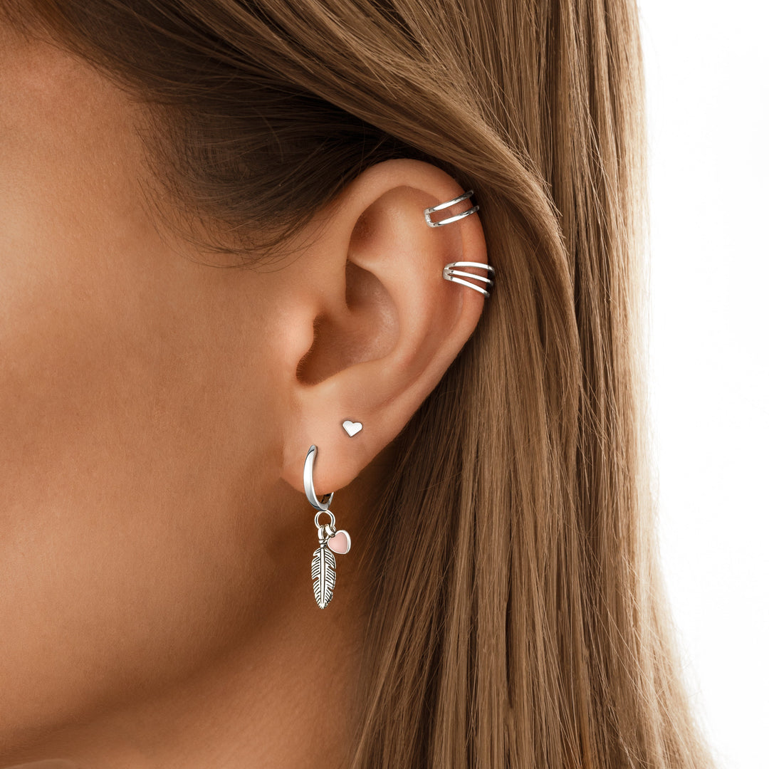 Romantic sterling silver hoop earrings for women, featuring a delicate feather and heart design. Symbolic and elegant.