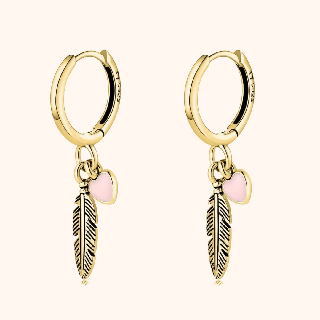 Delicate sterling silver hoop earrings, adorned with a charming feather and heart. Stylish women's feather & heart jewelry.