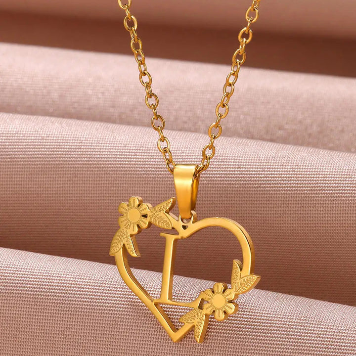 A personalized heart initial necklace featuring a custom letter in sterling silver, an elegant fashion accessory.