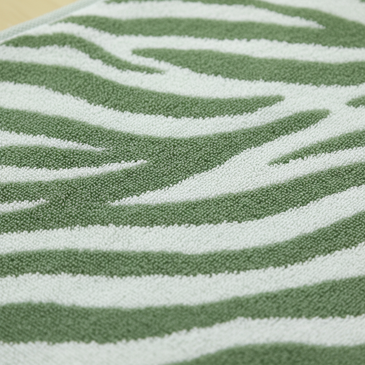 Folded striped cotton hand towel on a bathroom counter, modern decor, washable