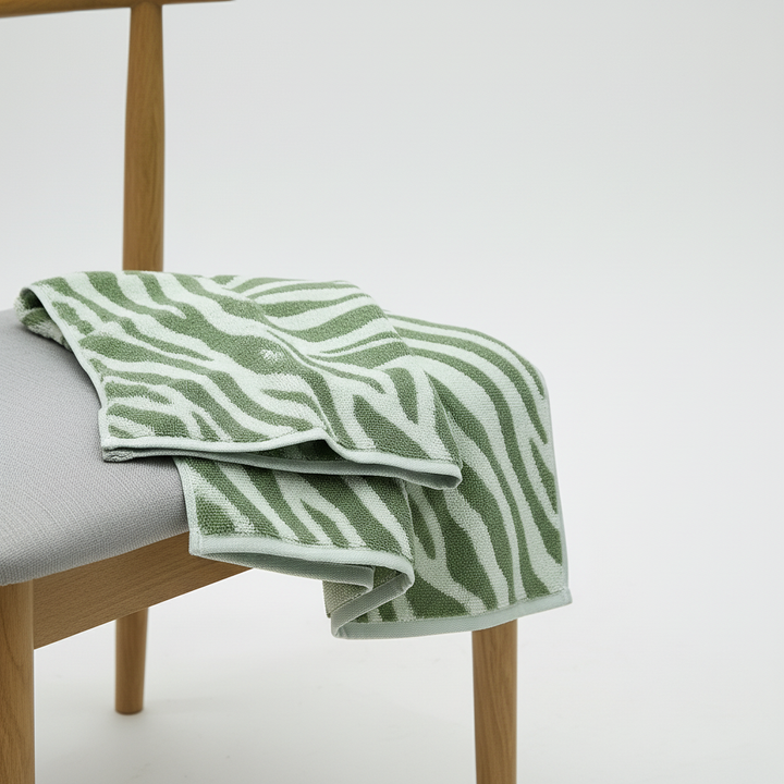 Striped cotton hand towel hanging on a towel rack, bathroom essential, soft touch
