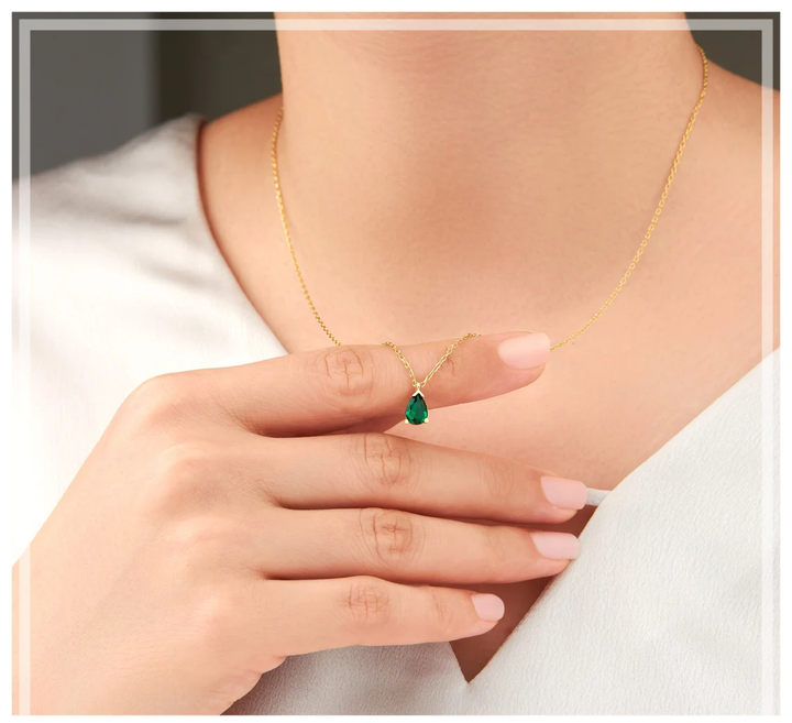 Stunning emerald drop necklace for women, crafted from sterling silver. Elegant fine jewelry with a vibrant gemstone.