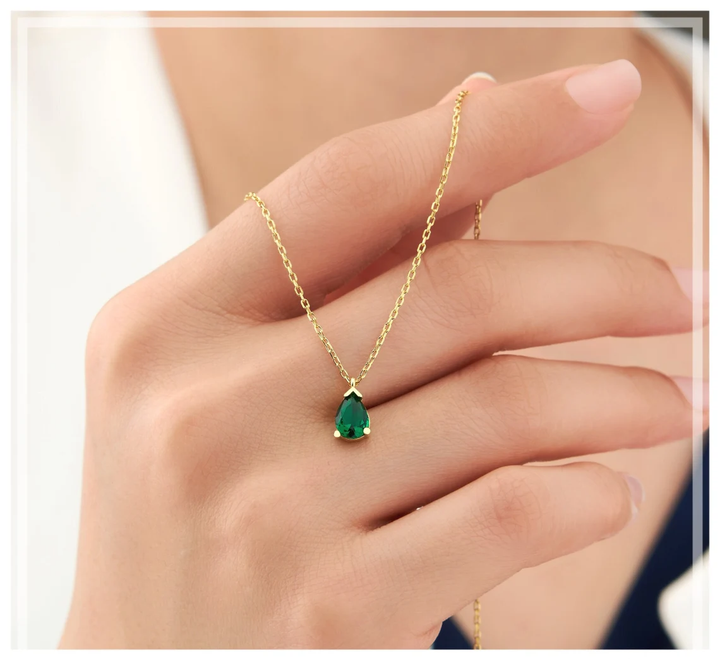 Elegant women's emerald drop necklace in sterling silver, a stunning fine jewelry gift with a beautiful green gemstone.