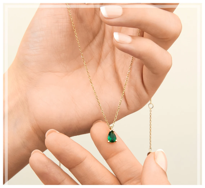 Vibrant emerald drop necklace for women, made with high-quality sterling silver. Stunning and elegant gemstone jewelry.