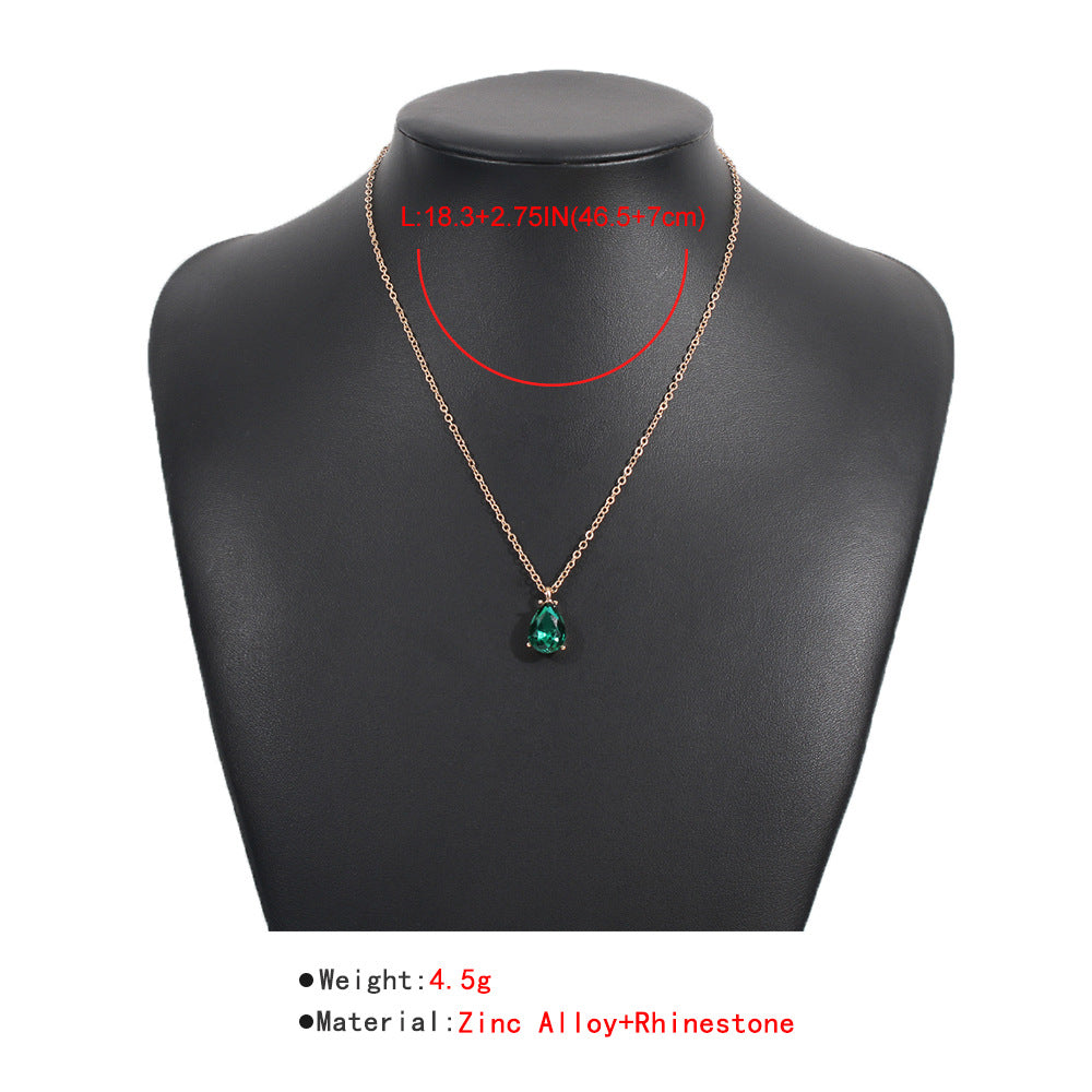 Women's stunning emerald drop necklace featuring a brilliant green gemstone. Elegant sterling silver fine jewelry piece.