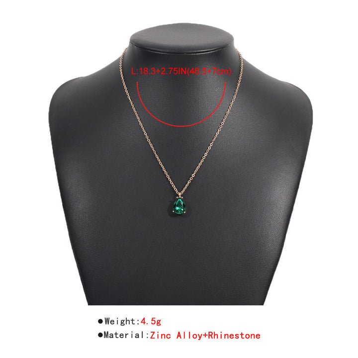 Women's stunning emerald drop necklace featuring a brilliant green gemstone. Elegant sterling silver fine jewelry piece.