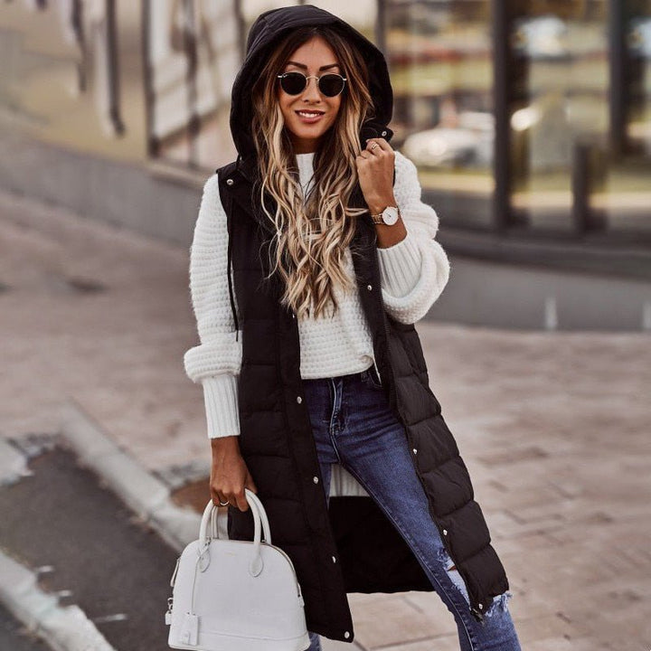 Stylish black knee-length padded bodywarmer for women, warm winter outerwear.