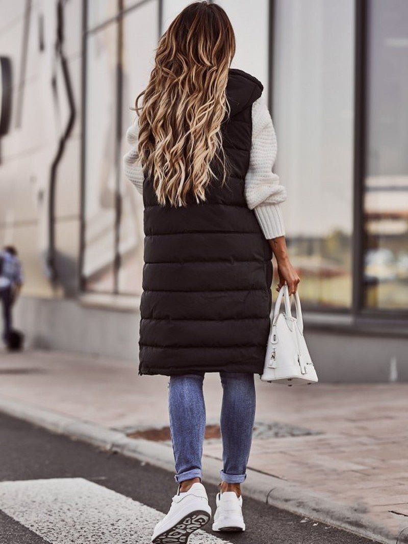 Elegant black long padded bodywarmer, knee-length, chic winter layering piece for women.