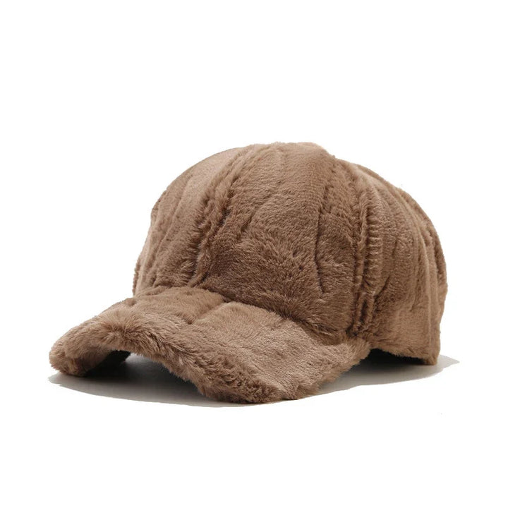 Elegant beige plush faux fur women's hat, a warm winter accessory. Adjustable for comfortable fit.