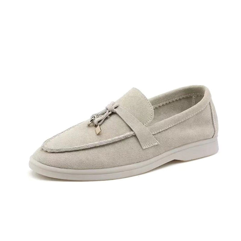 Stylish black women's loafers with elegant gold clasp, offering comfortable slip-on wear for all seasons.